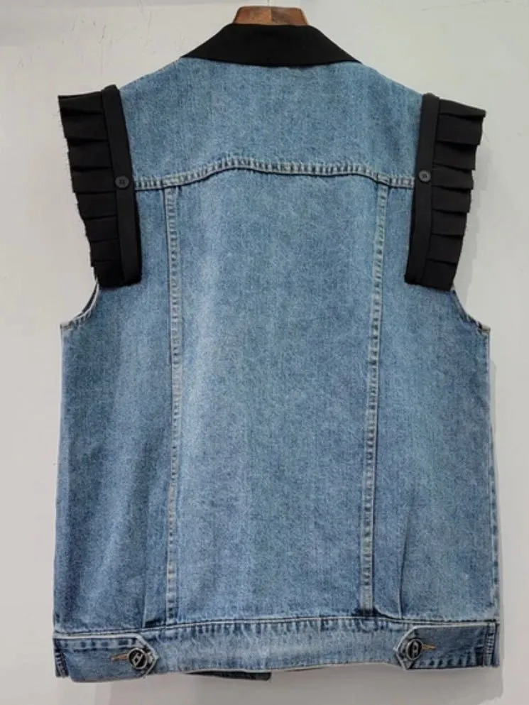 Blue jeans and black vest
