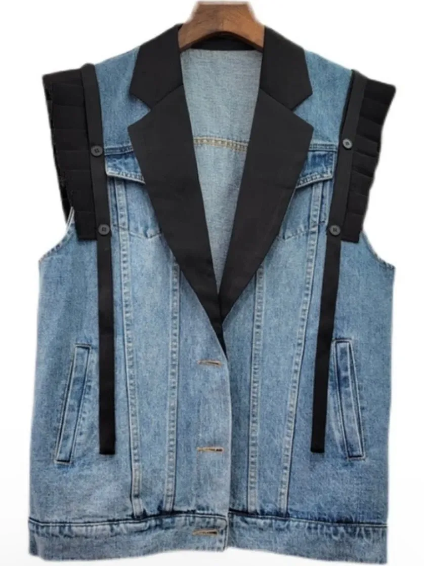 Blue jeans and black vest